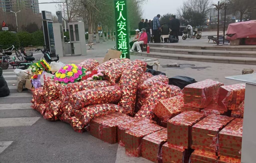 Vendors set up small stalls selling paper money